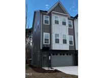 Modern townhouse featuring mixed siding, a two-car garage, and a welcoming front entrance at 2112 Opulent Oaks Ln # 7, Durham, NC 27713
