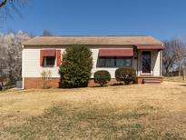 Charming ranch-style home with red awnings, vinyl siding, and a well-maintained lawn at 2116 Mckinney St, Burlington, NC 27217