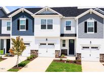New townhomes feature attached garages, black shutters, manicured lawns, and Craftsman-style details at 26 Twin Birch Dr, Angier, NC 27501