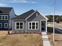 Charming home featuring gray siding, white trim, well-manicured lawn, and a welcoming walkway at 273 Marvel Dr # 139, Rolesville, NC 27571