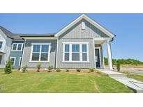 Charming gray home featuring a well-manicured lawn, a tidy garden and large windows that offers lots of natural light at 273 Marvel Dr # 139, Rolesville, NC 27571