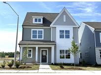 Charming two-story home featuring gray siding, white trim, and a welcoming front porch at 2880 Quarry Rd # 163, Rolesville, NC 27571