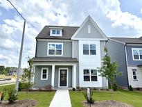 Charming two-story home with Hardie board siding and a well-manicured lawn on a sunny day at 2880 Quarry Rd # 163, Rolesville, NC 27571