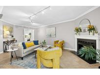 Bright living room features a cozy fireplace, stylish furniture, and neutral wall color at 308 Summerfield Crossing Road, Chapel Hill, NC 27514