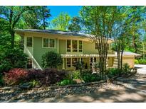 Charming two-story home with landscaped yard, beautiful trees, and a stone pathway at 402 Westwood Dr, Chapel Hill, NC 27516