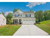 Charming two-story home with a two-car garage, gray siding, black shutters, and a well-maintained lawn at 511 Valentine Ct, Graham, NC 27253