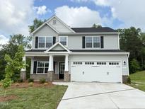 Charming two-story home with a gray exterior, a two-car garage, and a well-manicured front lawn at 511 Valentine Ct, Graham, NC 27253