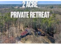Secluded 2-acre retreat featuring a charming home nestled amidst lush trees for ultimate privacy at 577 Dixon Rd # D, Willow Springs, NC 27592