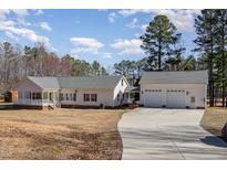 Lovely ranch style home with attached 3-car garage and beautiful lawn at 902 Zion Church Rd, Sanford, NC 27330