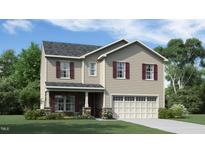 Charming two-story home features a classic design, well-manicured lawn, and inviting curb appeal at 909 Thimbleweed Way, Wake Forest, NC 27587