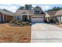 Charming home featuring a stone facade, well-maintained landscaping, and an attached two-car garage at 1009 Restoration Dr, Durham, NC 27703