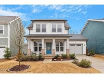 Charming two-story home featuring a welcoming porch, well-manicured lawn, and an attached garage at 190 Retreat Dr, Fuquay Varina, NC 27526