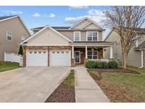 Charming two-story home features stone accents, double garage, and a welcoming front porch at 1938 Glenkirk Dr, Burlington, NC 27215