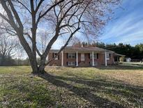Ranch style brick home featuring a large yard and charming curb appeal at 2117 George Winston Rd, Oxford, NC 27565