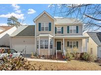 Charming two-story home featuring a covered front porch, bay window, and well-maintained landscaping at 2152 Haig Point Way Way, Raleigh, NC 27604