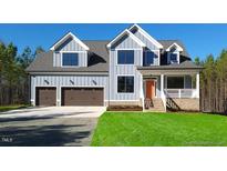 Charming two-story home featuring a large garage and well-manicured lawn at 4025 Hamlets Chapel Rd, Pittsboro, NC 27312