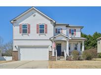 Charming two-story home featuring a well-manicured lawn and an inviting front porch perfect for relaxing at 505 Ferry Ct, Wake Forest, NC 27587