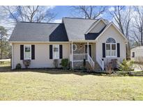 Charming single-story home featuring a cozy front porch and a well-maintained lawn at 7127 Lark Ln, Sanford, NC 27332