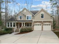 Stunning two-story home with stone accents, three-car garage and meticulously maintained front yard at 73006 Harvey, Chapel Hill, NC 27517