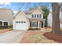 Charming two-story home with a well-manicured lawn and attached garage, perfect for a Gathering at 8412 Lunar Stone Pl, Raleigh, NC 27613