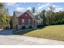 Beautiful two-story home with a stone and brick facade and a well-manicured lawn at 1001 Jarrett Bay Rd, Willow Springs, NC 27592