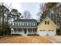 Charming two-story home with a welcoming front porch and attached two-car garage at 1007 Surry Dale Ct, Apex, NC 27502
