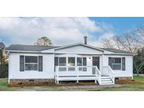 Charming home featuring a front porch, white siding, and black shutters at 110 Hickory Dr, Spring Hope, NC 27882