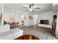 Open-concept living room and dining area with modern furnishings, hardwood floors, and a ceiling fan at 1110 Schaub Dr # B, Raleigh, NC 27606