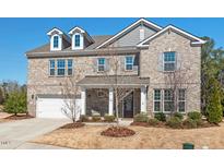 Charming brick two-story home featuring well-maintained landscaping and a welcoming front porch at 126 Filigree Way, Durham, NC 27713