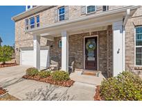 Charming brick home with a welcoming front porch and manicured landscaping at 126 Filigree Way, Durham, NC 27713