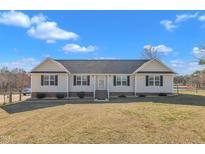 Charming one-story home featuring a well-manicured lawn and ample parking at 130 Hardy Rd, Wendell, NC 27591