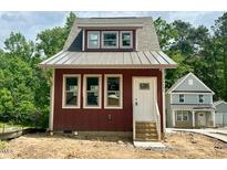 Charming home with a welcoming front entrance, ample windows, and meticulous landscaping at 1448C Maplewood Dr, Durham, NC 27704