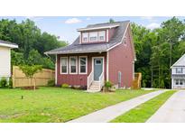 Charming home featuring a landscaped front yard with a freshly painted, modern exterior at 1448C Maplewood Dr, Durham, NC 27704