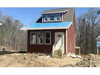 New construction home featuring wood siding and a covered porch, set on a partially landscaped lot at 1448C Maplewood Dr, Durham, NC 27704