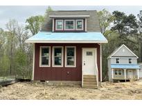 New construction home with red siding, white trim, and a dormer window ready for a Gathering at 1448C Maplewood Dr, Durham, NC 27704