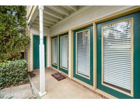 Inviting covered front entrance with a colorful welcome mat and beautiful green door and trim at 2011 Quaker Lndg # 101, Raleigh, NC 27603