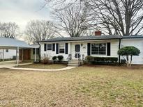 Charming one-story home with white siding, black shutters, and a covered carport at 215 Sallinger St, Knightdale, NC 27545