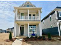 Charming two-story home featuring a covered porch, balcony, and stylish architectural details in a newly developed neighborhood at 30 Nimble Way # 171, Clayton, NC 27520