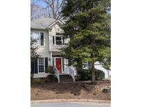 Charming two-story home features a bright red front door and a well-manicured lawn at 3109 Benton Cir, Raleigh, NC 27615