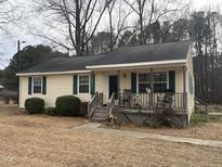 Charming single-story home with a welcoming front porch and classic green shutters at 3521 Cheek Rd, Durham, NC 27704