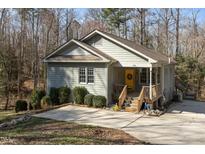 Charming home with a welcoming front porch and bright yellow door at 3741 Manly Farm Rd, Wake Forest, NC 27587