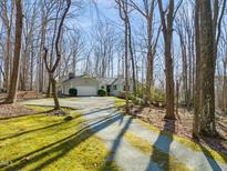 Well-maintained ranch style home with an attached garage nestled on a wooded lot with a long private driveway at 405 Lookout Pt, Rougemont, NC 27572