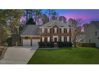 Charming brick two-story home with a well-manicured lawn and two-car garage at 4617 Wee Burn Trail, Raleigh, NC 27612