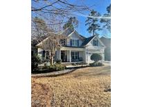 Charming two-story home with a covered front porch and manicured landscaping, perfect for curb appeal at 528 Opposition Way Way, Wake Forest, NC 27587