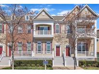 Inviting townhome exterior with multiple levels, a covered porch, and freshly landscaped grounds at 10510 Sablewood Dr # 108, Raleigh, NC 27617