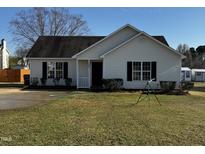 Charming one-story home featuring well-manicured lawn and classic curb appeal at 128 Glengariff Ln, Clayton, NC 27520