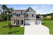 Charming two-story home with a two-car garage, a covered porch, and a nicely manicured lawn at 18 Cribbs Ln, Middlesex, NC 27557