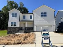 Charming two-story home with white siding, stone accents and an attached two-car garage at 1912 Harrell Cove Ct # 171 Gunnison Cr, Fuquay Varina, NC 27526