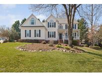 Charming two-story home with white siding, black shutters, and well-manicured front lawn at 201 Gingergate Dr, Cary, NC 27519