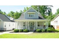 Charming home features a covered porch, well-maintained lawn, and inviting curb appeal at 206 Pine St, Fuquay Varina, NC 27526
